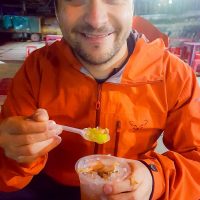 Silviu tasting a local dessert at the night market