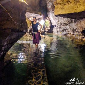 Walking in the flooded Mua Cave