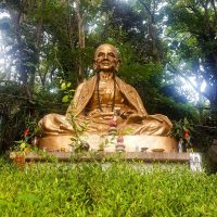 A big beautiful statue of a monk outside the temple