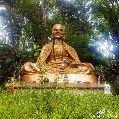 A big beautiful statue of a monk outside the temple