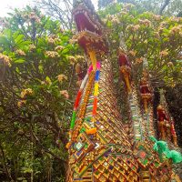 Dragon and frangipani flowers at the entrance of the staircase