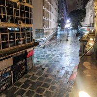 At night the streets of the city center are empty except for homeless people sleeping on the side